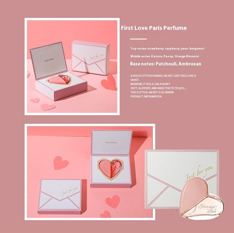 Perfume display with heart-shaped packaging on a pink background.