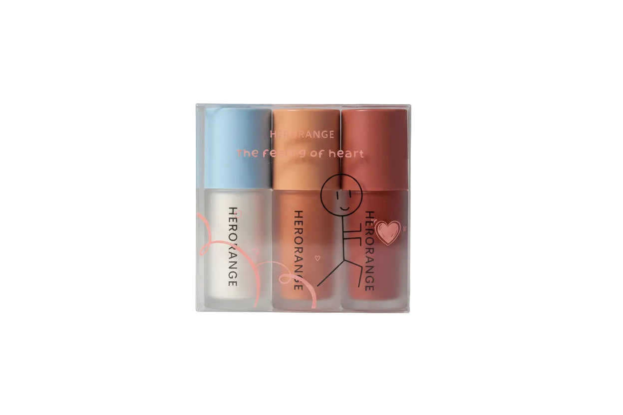 Three lip products in a clear packaging with 'HERORANGE' branding on a white background.