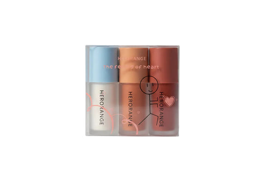 Three lip products in a clear packaging with 'HERORANGE' branding on a white background.