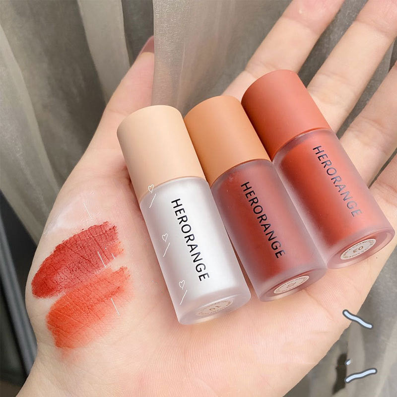 Three lipsticks from HERORANGE on a hand with swatches.