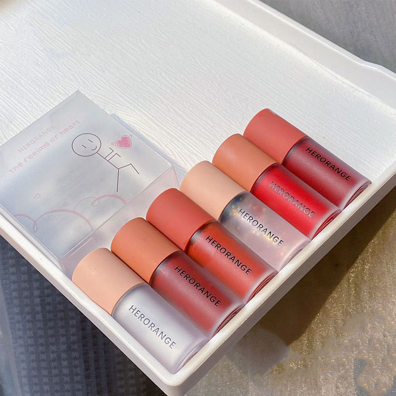 Set of Herorange lipsticks in a box on a textured surface
