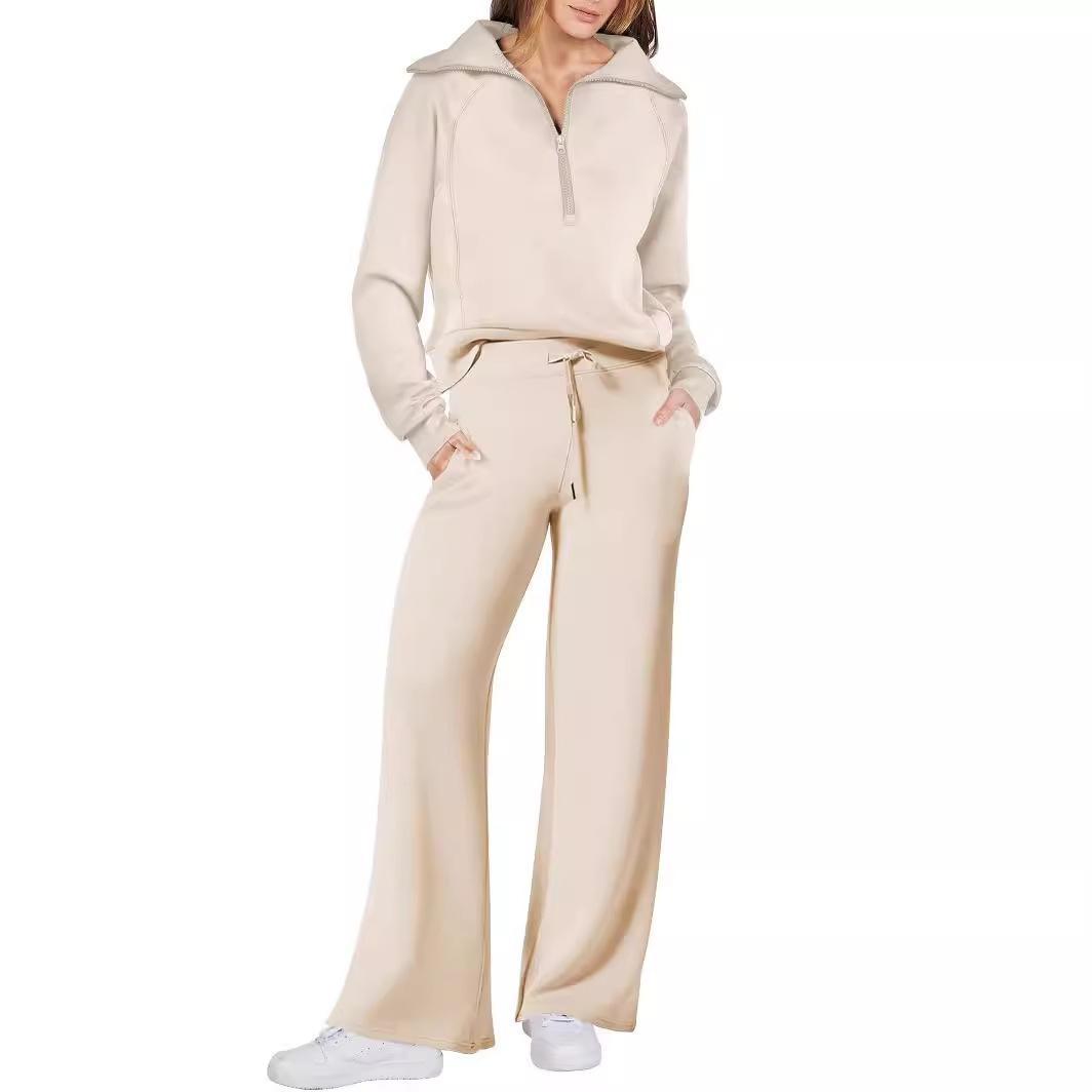 Person wearing a beige tracksuit on a white background
