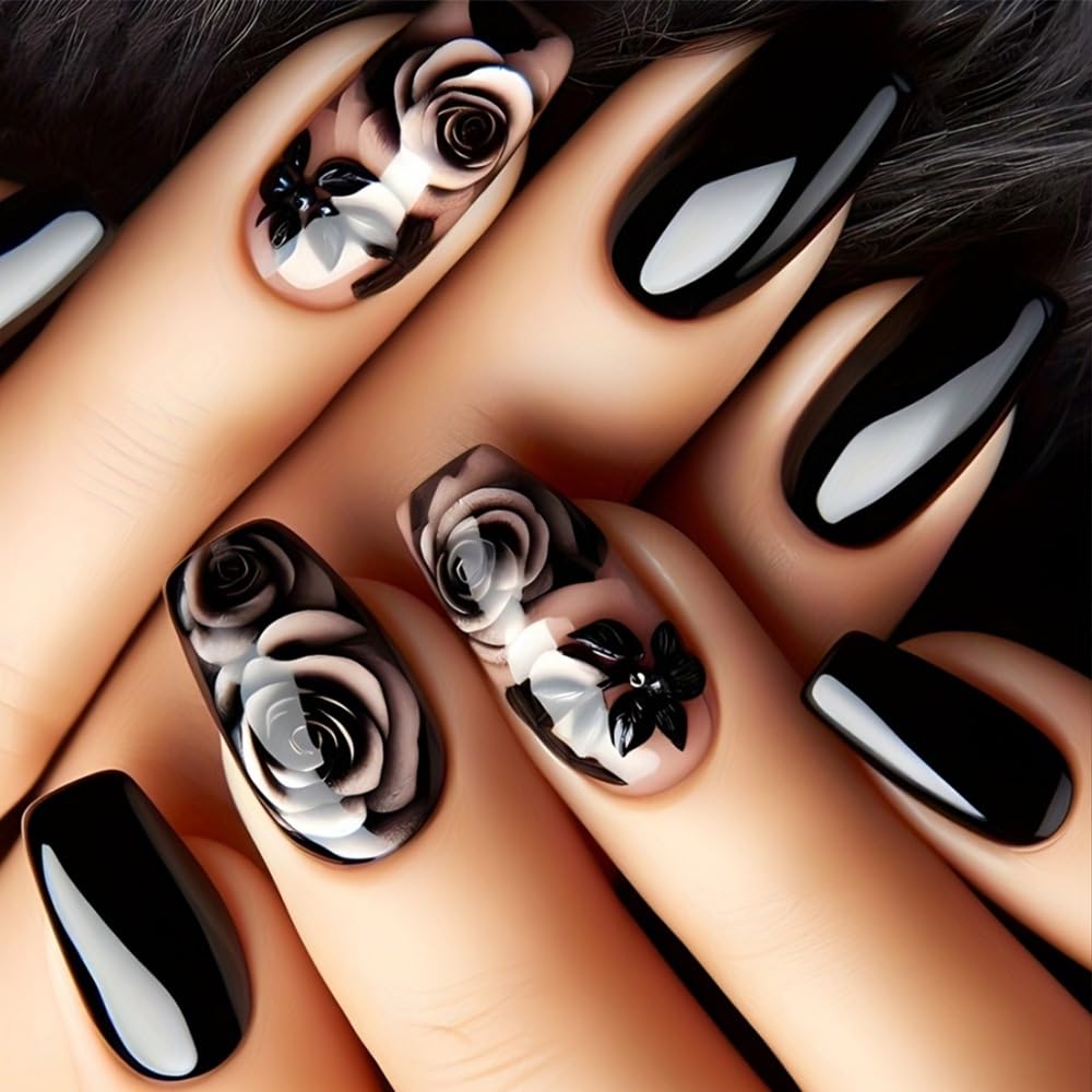 Close-up of hands with black and white floral nail art