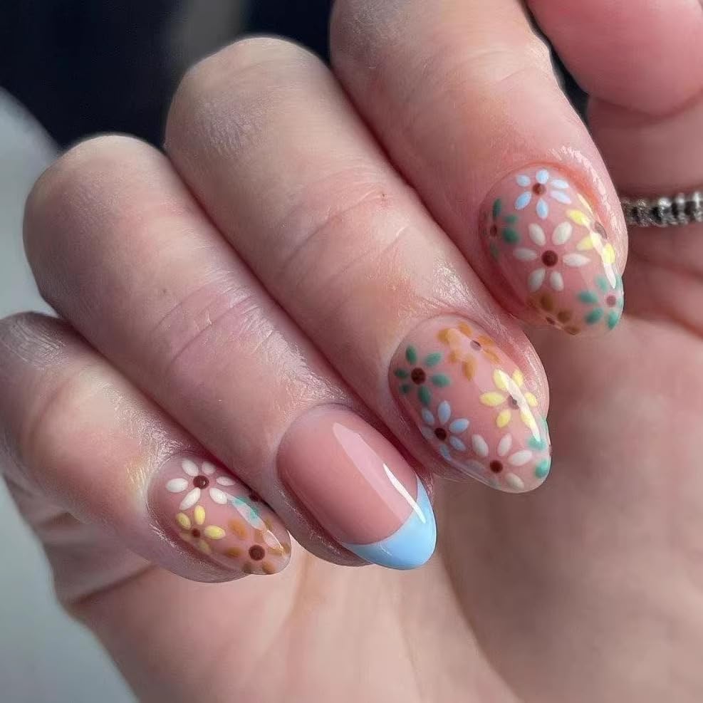 Close-up of a hand with floral nail design on a neutral background