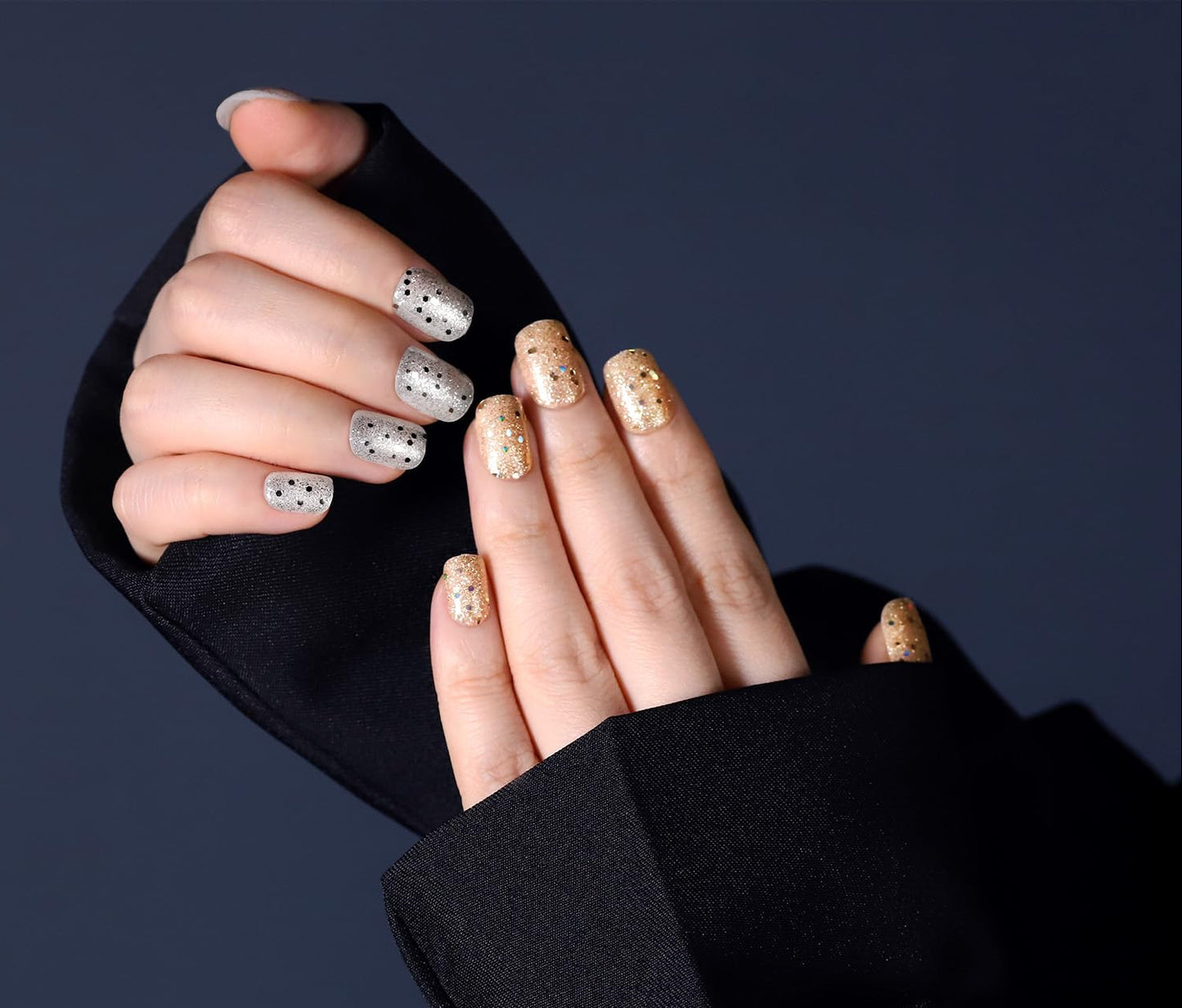 Close-up of hands with decorative nail art wearing a black sleeve against a dark background, featuring the Fandamei brand logo.