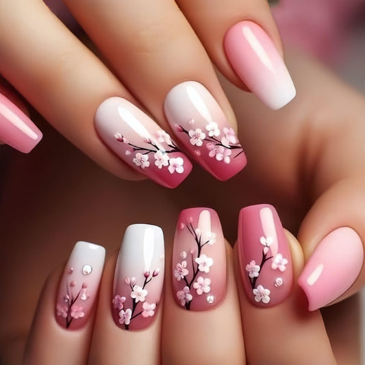 Nails with cherry blossom design and pink and white gradient
