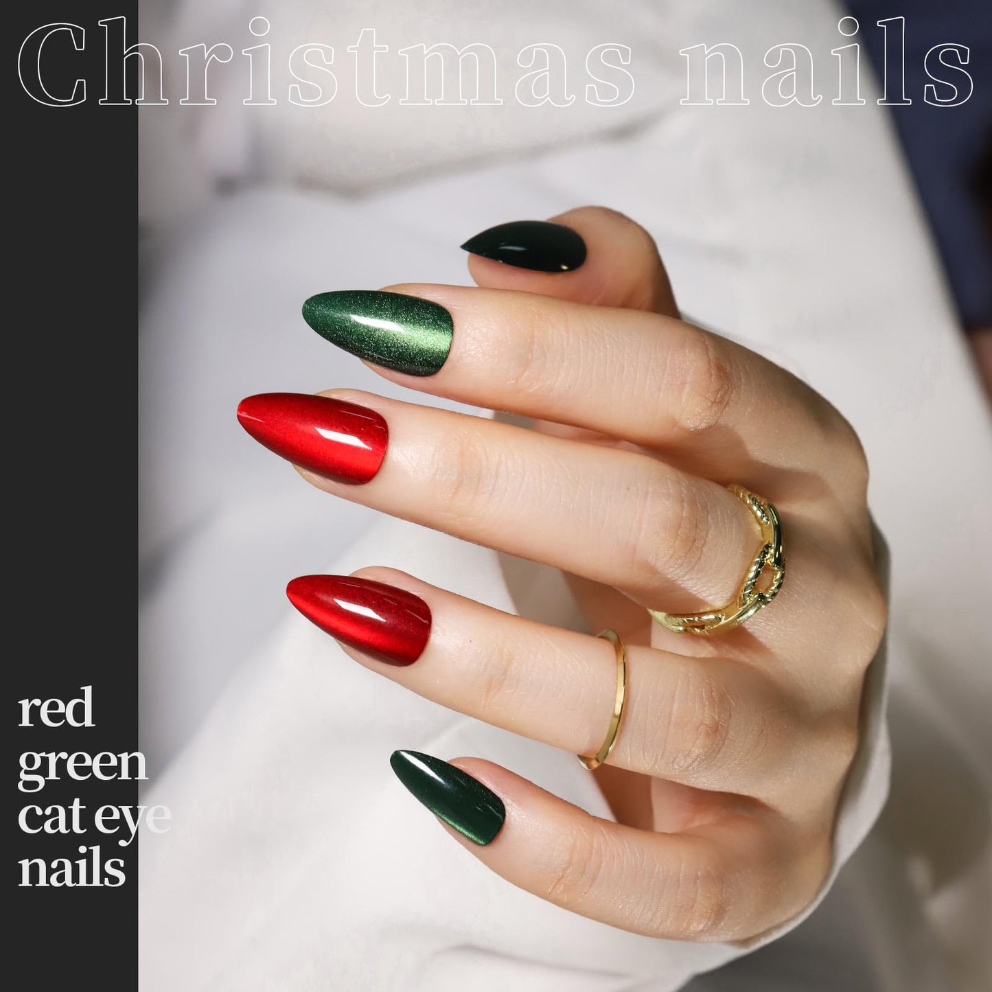 Hand with red, green, and black cat eye nails on a white background