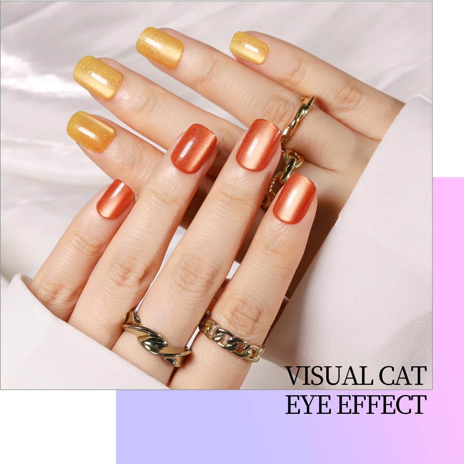 Hand with orange and yellow nail polish wearing gold rings on a light background