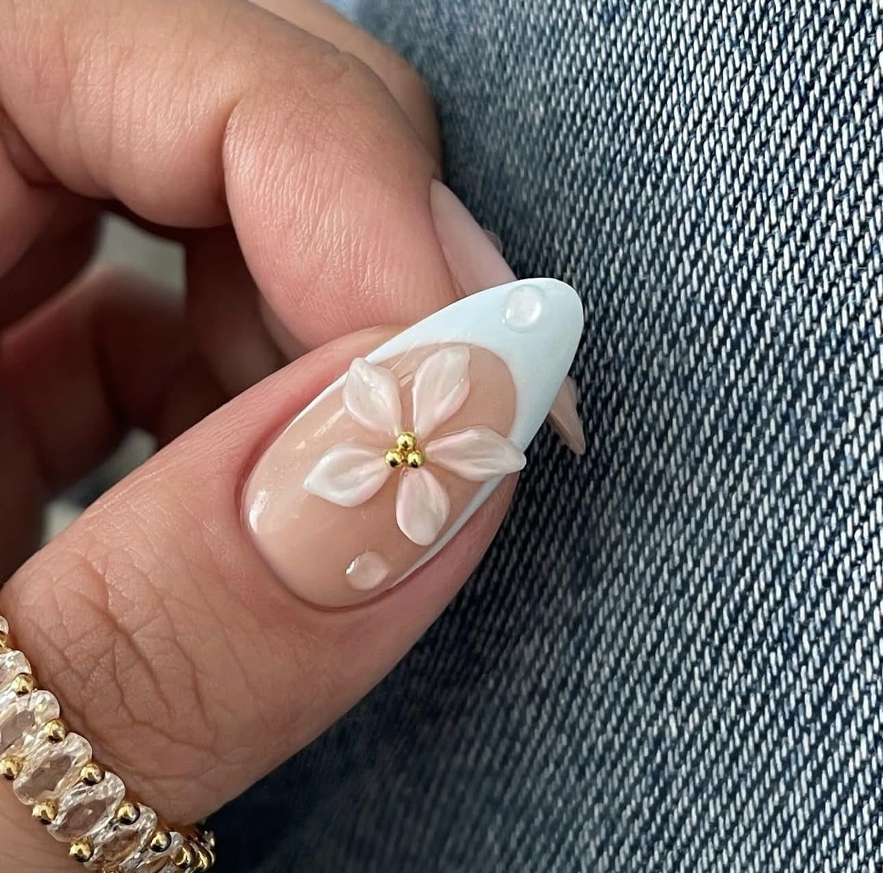 Nail with floral design on a denim background