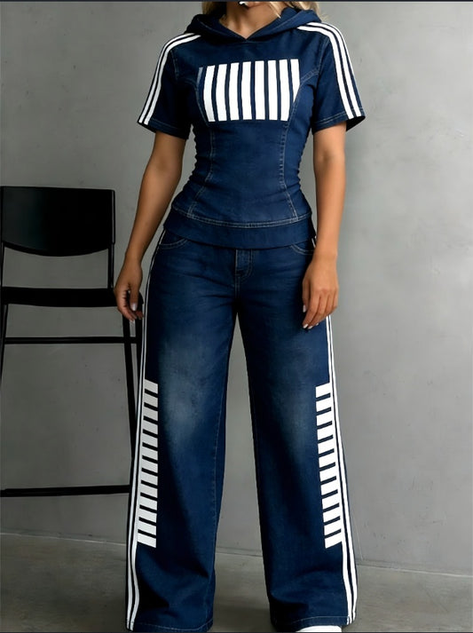 Person wearing a navy tracksuit with white stripes against a gray background